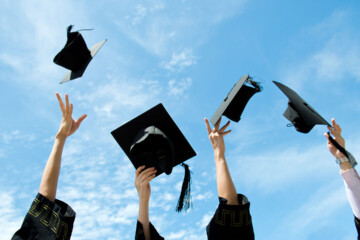 college students throwing caps