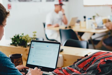 Man working on computer in coffeeshop