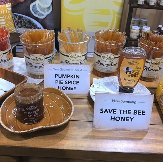 Honey products and sticks on table