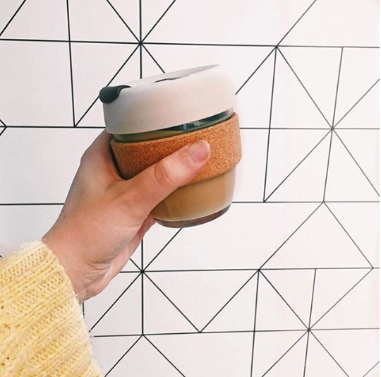 Reusable cup in front of wall