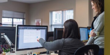 Two women working on a desktop