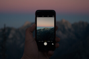 Person taking photo of a mountain for social media