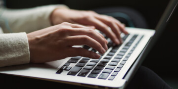 Person typing on a keyboard