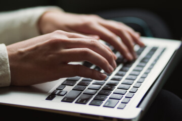 Person typing on a keyboard