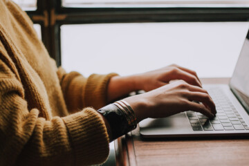 person typing on laptop