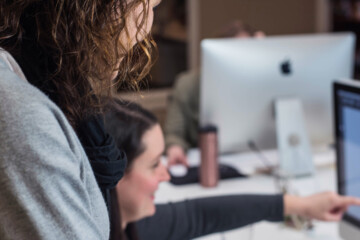 Two people looking at a computer