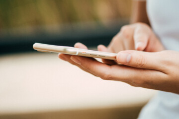 Person scrolling on smartphone