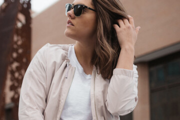 Woman wearing jacket and sunglasses