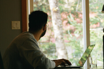 Person looking out the window while working