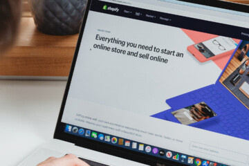 person typing on laptop with ecommerce site open.